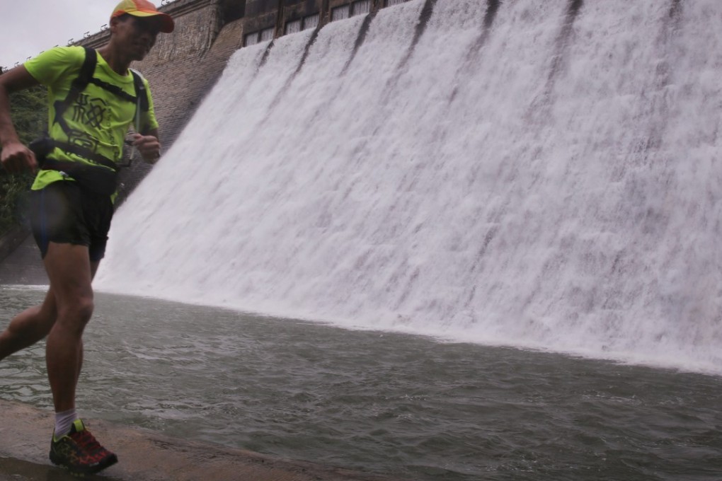 A man runs in the rain at Tai Tam dam. June’s rainfall has already surpassed the 30-year average for the whole month. Photo: Sam Tsang