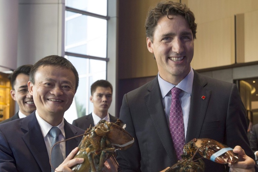 Alibaba Group founder Jack Ma and Canadian Prime Minister Justin Trudeau (right) pick up lobsters during their meeting at Alibaba's headquarters in Hangzhou: Photo: AP