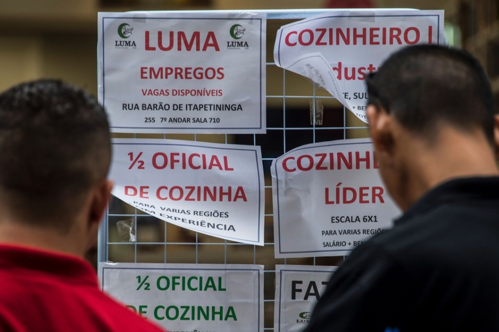 Unemployed people read announcements of job offers in downtown Sao Paulo, Brazil. The country started to emerge from its worst ever recession in the first quarter, but officials and analysts say it may not be out of the woods yet with a weak economic recovery threatened by political turmoil. Photo: AFP