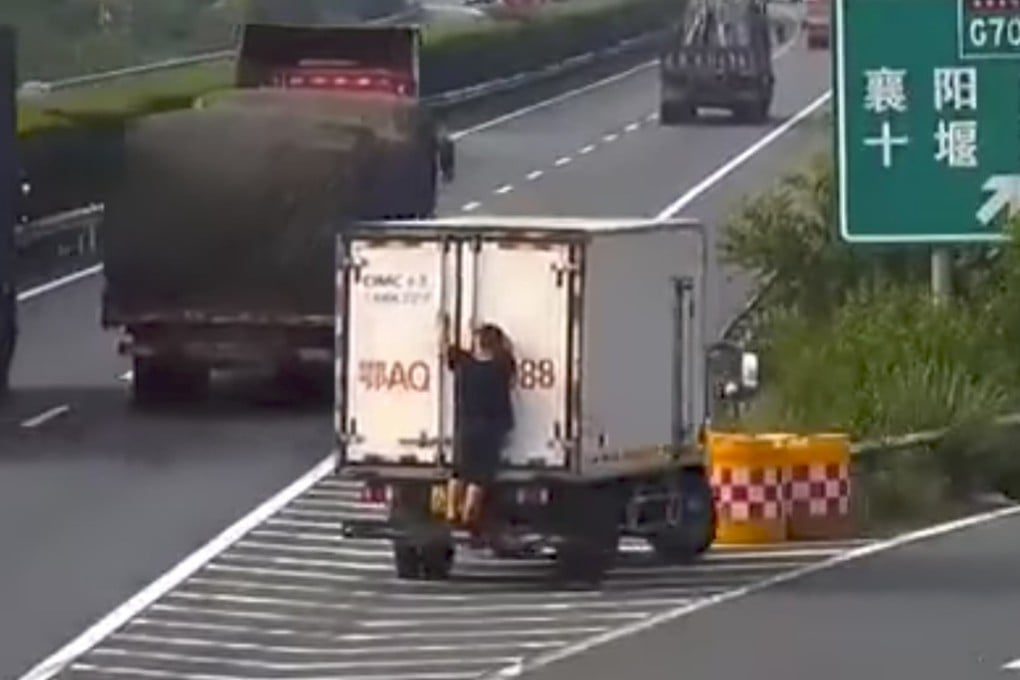 The van’s passenger tries in vain to hide the vehicle’s licence plate from a surveillance camera. Photo: Handout