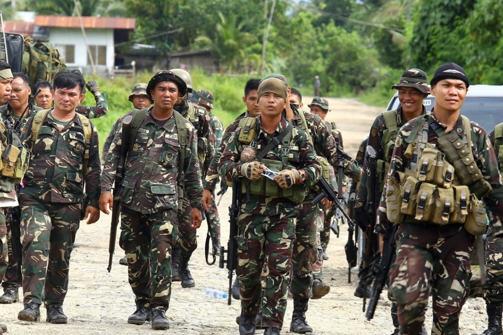 Philippine soldiers patrol a road at Pigcawayan, a farming town about 160 kilometres from Marawi city. Photo: AFP