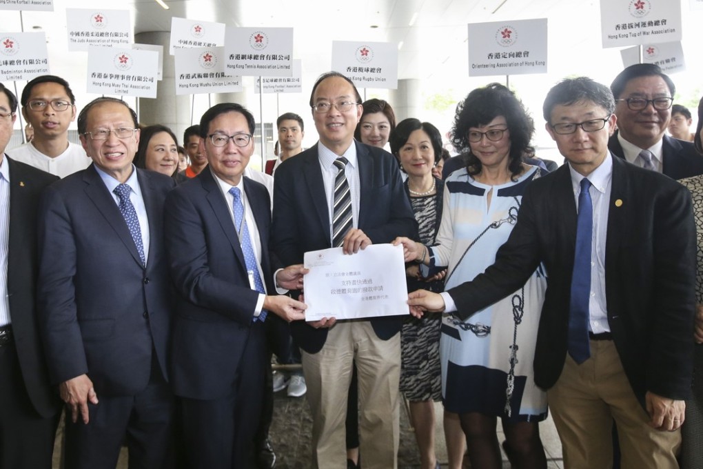 The petition from 73 national sports associations was handed to the committee chairman Chan Kin-por (third left). Photo: David Wong