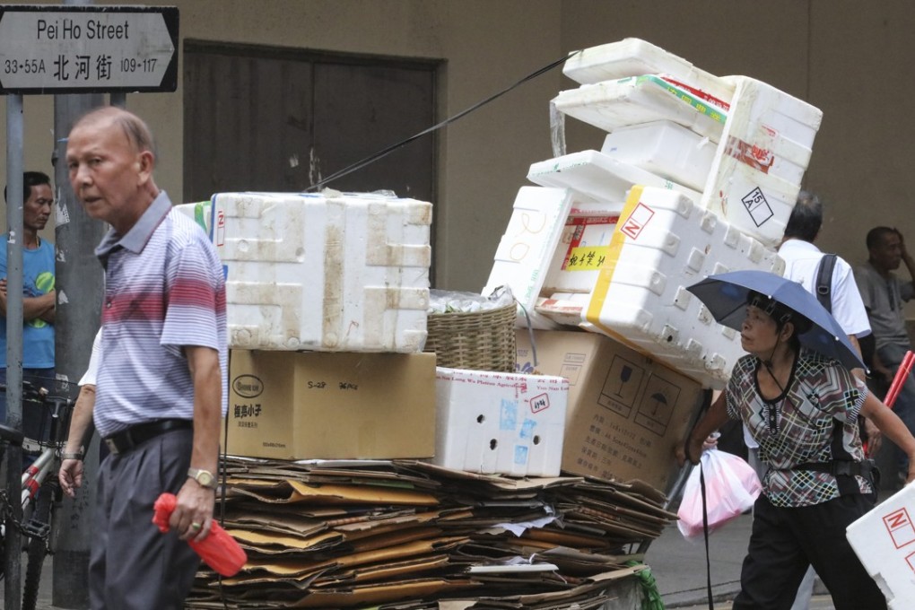 General photo of an elderly woman collecting cardboard and styrofoam boxes in Sham Shui Po. Photo: Felix Wong