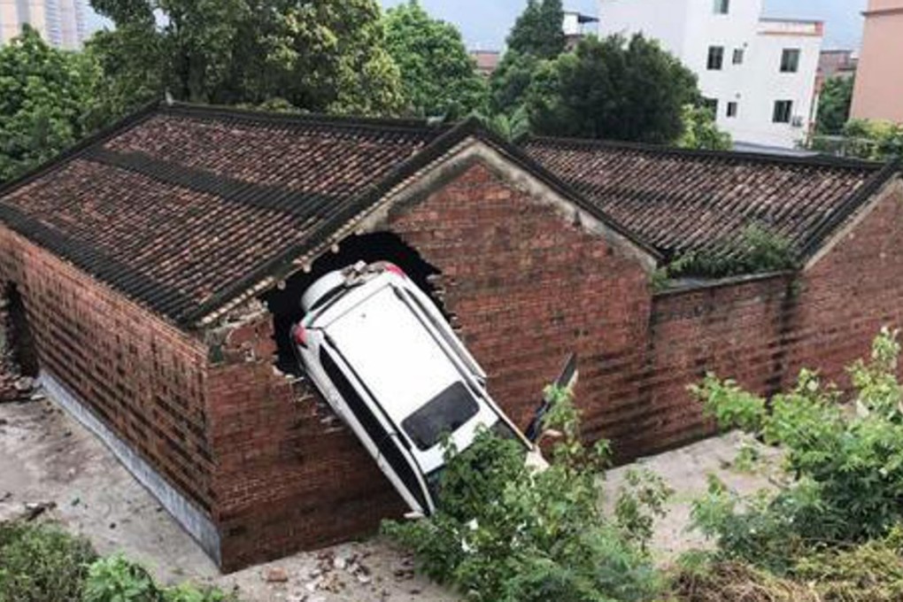 The SUV skidded off the road and rolled front over end into the temple’s wall. The hole to the left was the result of an accident on June 6. Photo: Handout