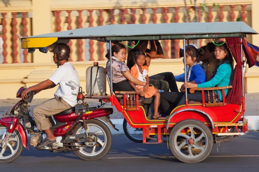 A family travels via tuk-tuk in Phnom Penh, Cambodia. Handout photo