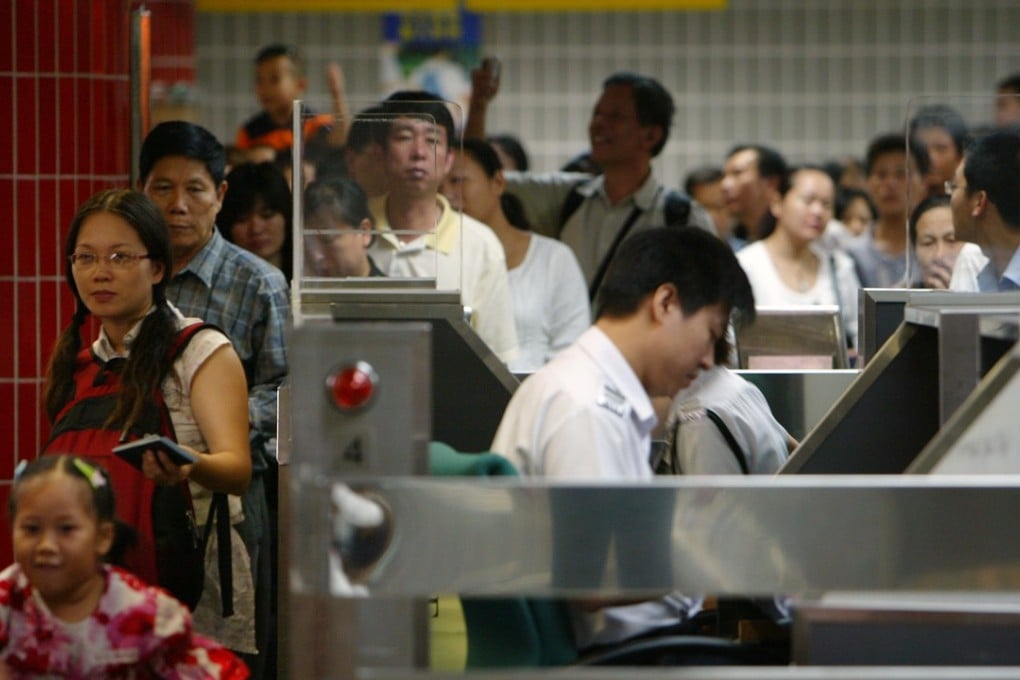Mainland tourists at the immigration counter in Lo Wu Control Point. Photo: Dustin Shum