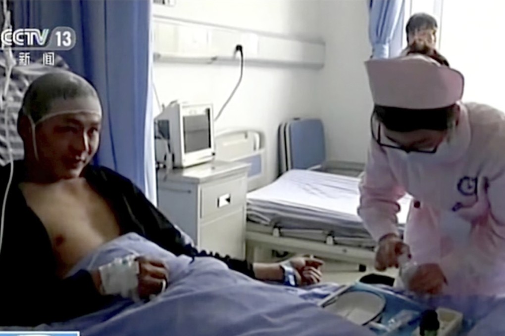 Qiao Dashuai is treated for minor injuries by a nurse at the nearby Mao county hospital. Photo: CCTV