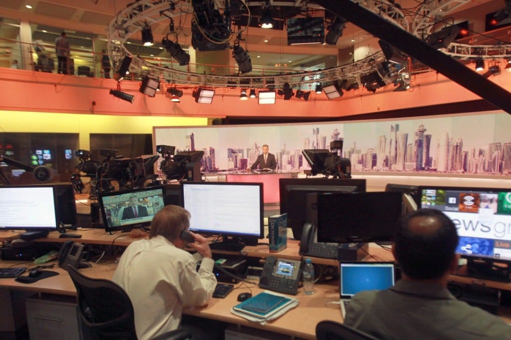 Staff members of Al-Jazeera International work at the news studio in Doha, Qatar. Photo: Reuters