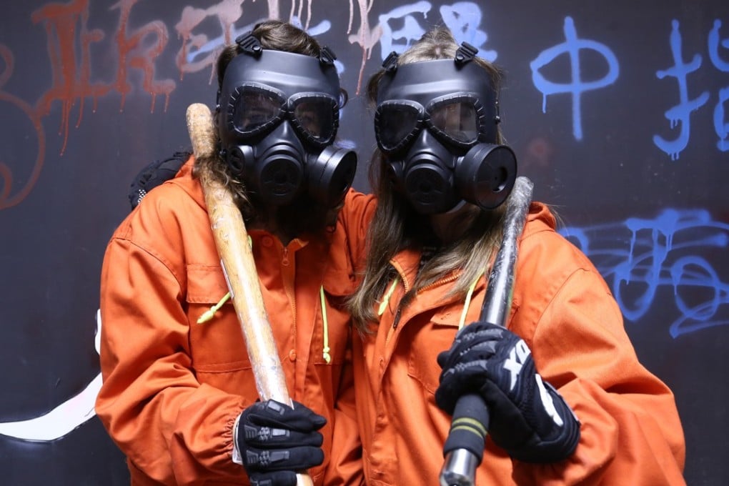 Reporters Julia Hollingsworth (left) and Rachel Blundy in full anger gear and equipment at Ikari Area, Hong Kong’s first rage room therapy. Photo: Jonathan Wong