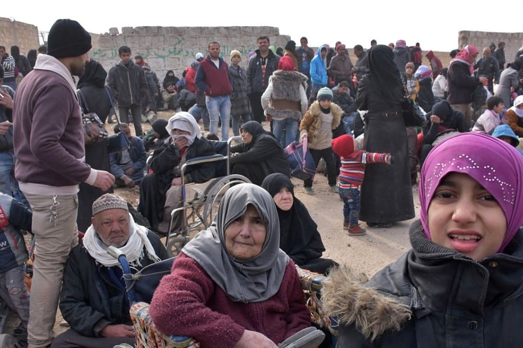 Syrian families fleeing the fighting in Aleppo as the country’s civil war rages in 2016. Photo: AFP