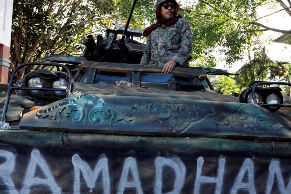 A Philippine soldier stands on an armoured vehicle inside the city hall compound in Marawi as government forces continue their assault against insurgents from the Maute group. Photo: Reuters