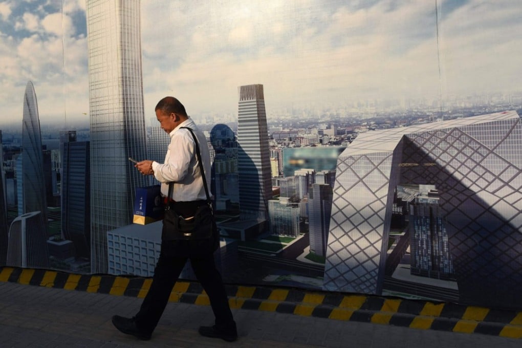 A man uses a smartphone in Beijing. Companies in the TMT sector say 38 per cent of compliance related investigations were for anti-bribery reasons. Photo: AFP