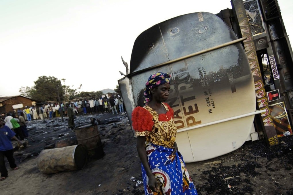 An inhabitant of the town of Sange, eastern Congo, walks past the burned out wreckage of a tanker truck in 2010. The blast killed 292 people. File photo: Reuters
