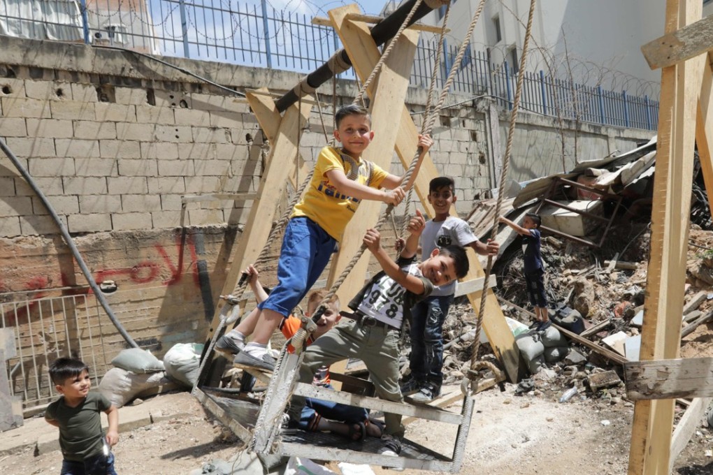 Syrian refugee children play on swings in the Shatila Palestinian refugee camp in the Lebanese capital, Beirut. Photo: AFP