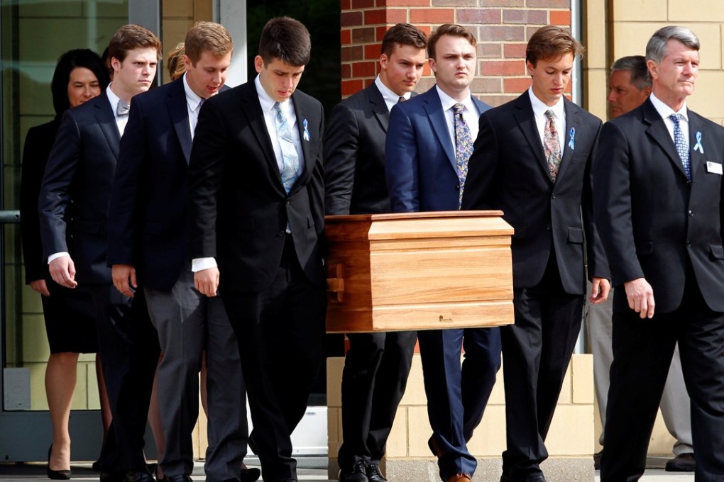 The casket of Otto Warmbier is carried to the hearse followed by his family and friends after a funeral service. Photo: Reuters