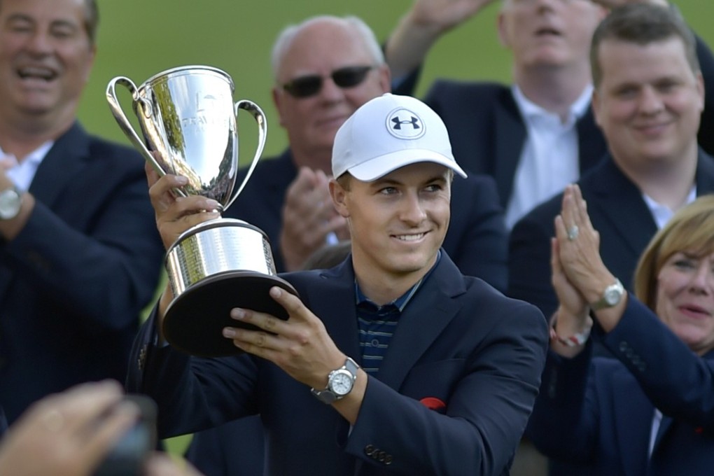 Jordan Spieth holds up the Travelers Championship. Photo: AP