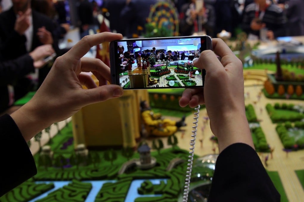 ZTE chairman Yin Yimin, told shareholders at the company’s annual meeting last week that he wants to increase investments in 5G research, development and marketing, while providing improved service to major customers in strategic markets. A man checks ZTE Axon7 device at Mobile World Congress in Barcelona. Photo: Reuters