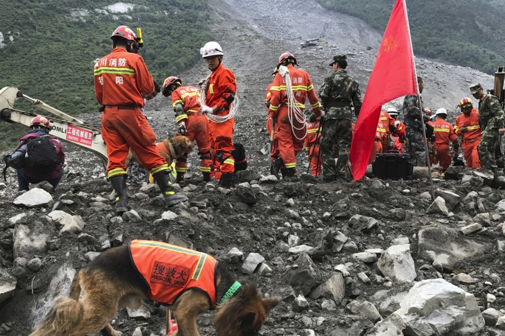 Rescue workers with sniffer dogs at the scene of the disaster in Sichuan province. Photo: Associated Press