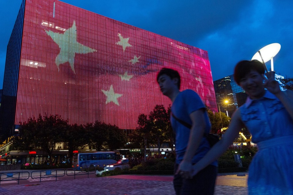 A couple walk past an image of the Chinese flag being projected on a building in Tsim Sha Tsui, ahead of the 20th anniversary of Hong Kong’s return to Chinese rule. China is a unitary nation, and the central government is responsible for the governance of its regions, for better and for worse. Photo: EPA