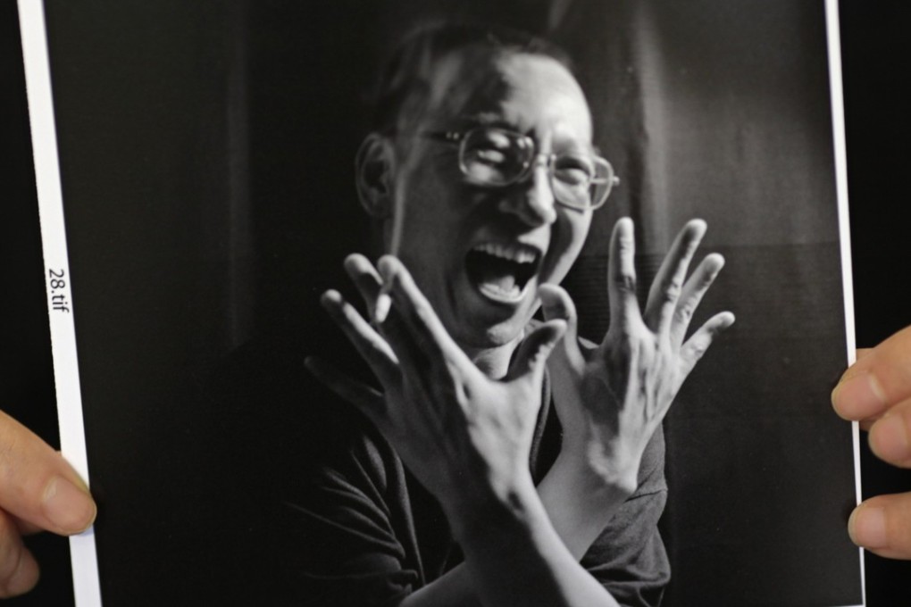 A photograph of Chinese dissident Liu Xiaobo is held by his wife Liu Xia. Photo: Reuters