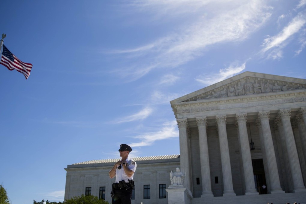 A police officer is seen outside the US Supreme Court after it was announced that the court will allow a limited version of President Donald Trump's travel ban to take effect on Monday, June 26, 2017. The Supreme Court will consider the case of the president's power on immigration in the fall. Photo: AFP