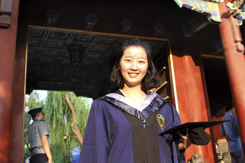 Zhang Yingying poses for photos during graduation at the entrance to Beijing University in China in 2016. Photo: Zhao Kaiyun via AP