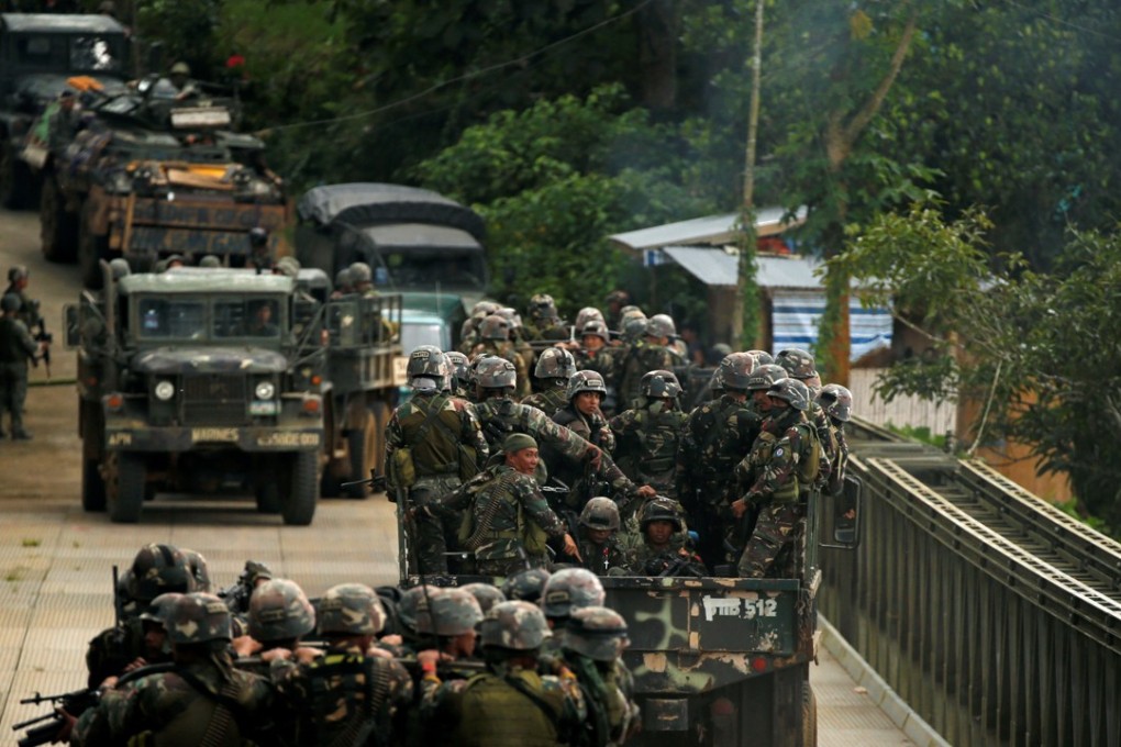 Philippines army soldiers ride in trucks into the fighting zone as government troops continue their assault against insurgents in Marawi City. Photo: Reuters