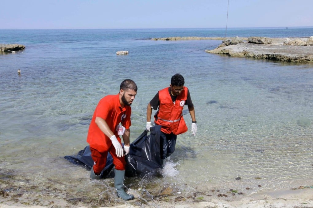 Rescuers carry a bag containing the dead body of a migrant at the coast of Tajoura, east of Tripoli, Libya, on June 27, 2017. Photo: Reuters