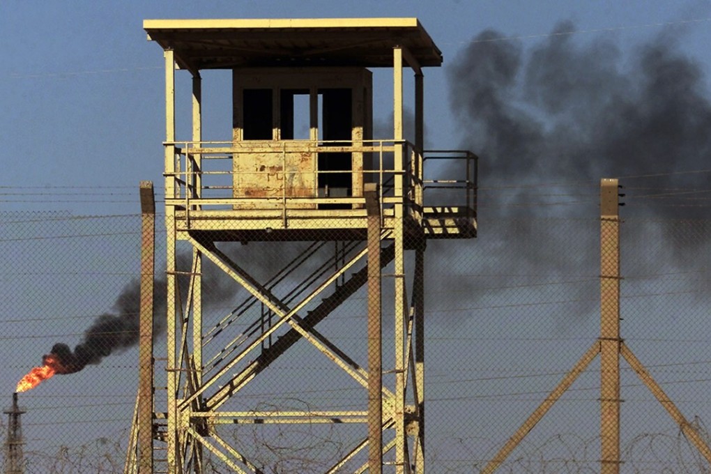 Smoke rises from a petroleum gas flare at Iraq’s largest oil refinery in this 2003 file photo. Years of violent conflict and neglect have devastated the country’s power infrastructure. Photo: AP