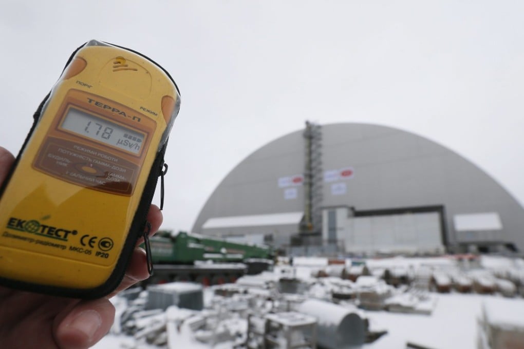 A dosimeter shows the radiation level near the Chernobyl nuclear power plant in Ukraine, in a file photo taken last year. Automatic monitoring systems at the disaster site were taken offline by a cyber attack that forced staff to check radiation levels with hand-held meters on Tuesday. Photo: EPA