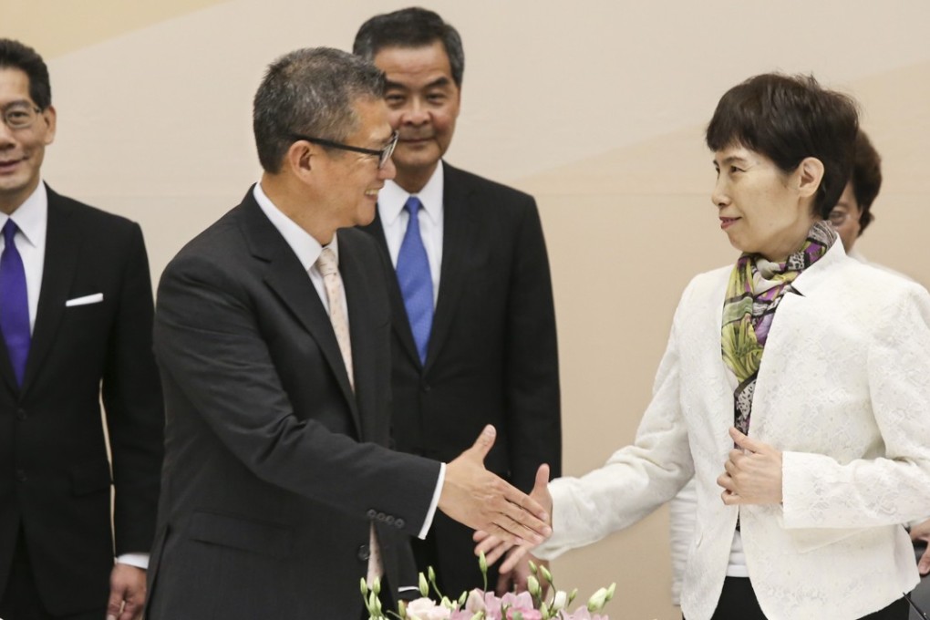 Financial Secretary Paul Chan Mo-po (left) shakes hands with the central government’s commerce undersecretary Gao Yan (right) at Tamar on Wednesday. Photo: Dickson Lee