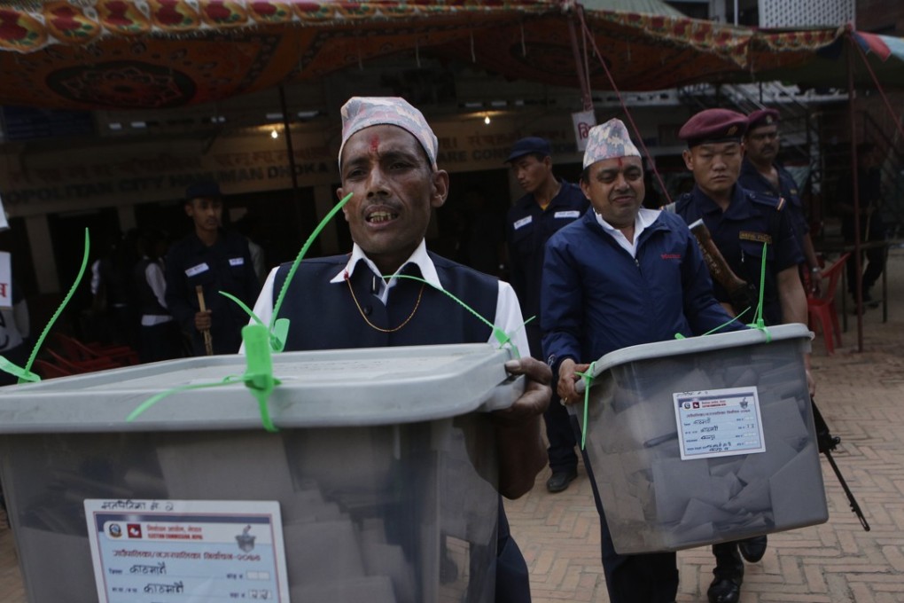Nepalese election commission staff carry ballot boxes in Kathmandu in May. Photo: AP