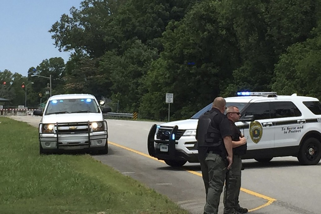 Authorities block an entrance to Redstone Arsenal, on Tuesday, June 27, 2017, in Huntsville, Alabama. The military post said in a tweet it was on lockdown amid reports of possible active shooter, telling workers to "run hide fight." More than 30,000 government employees, civilians and contractors work daily at Redstone. Photo: AP