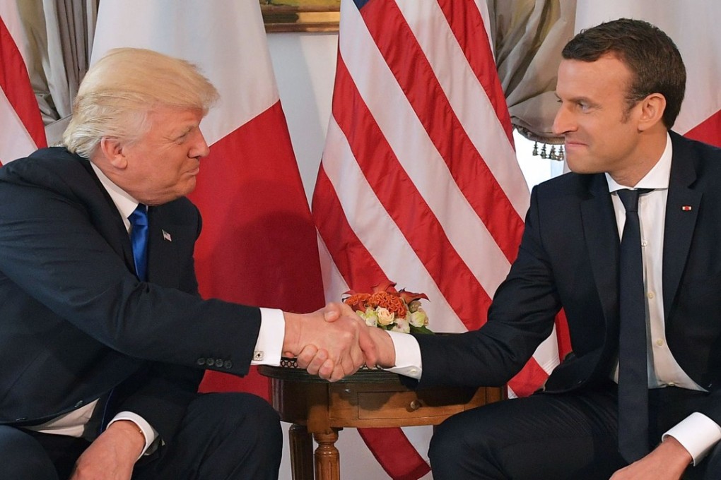 This file photo taken on May 25, 2017 shows US President Donald Trump (L) and French President Emmanuel Macron shake hands ahead of a working lunch, at the US ambassador's residence in Brussels. Macron invited US President Donald Trump on June 27, 2017 to attend the country's national day parade next month on July 14. Photo: AFP