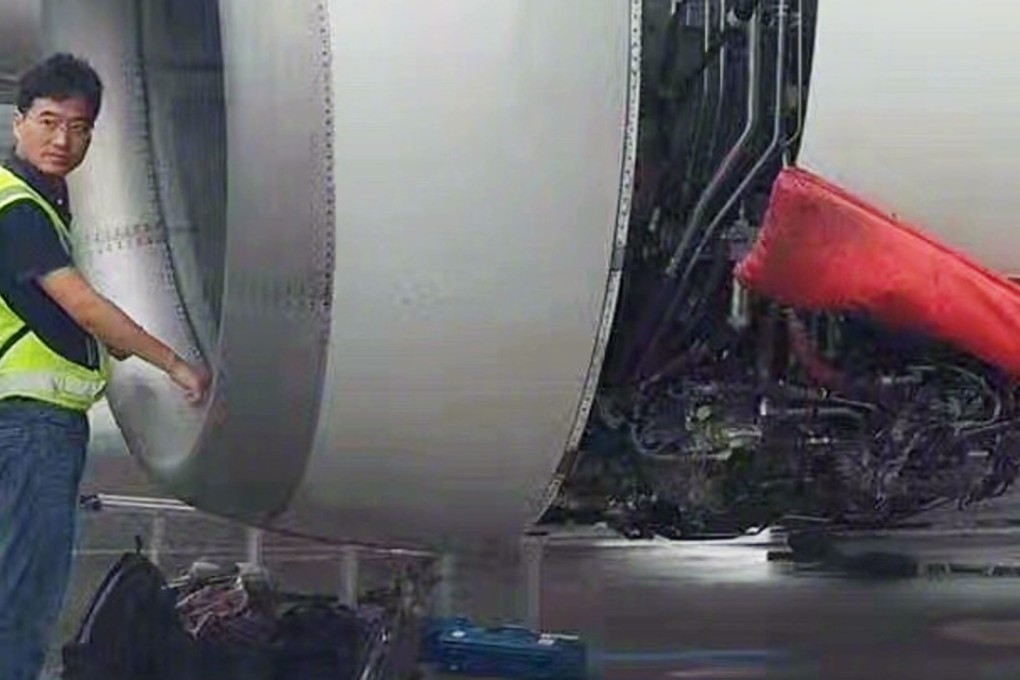 A worker searches for coins thrown into the engine of China Southern Airlines flight 380 from Shanghai to Guangzhou. Photo: Handout