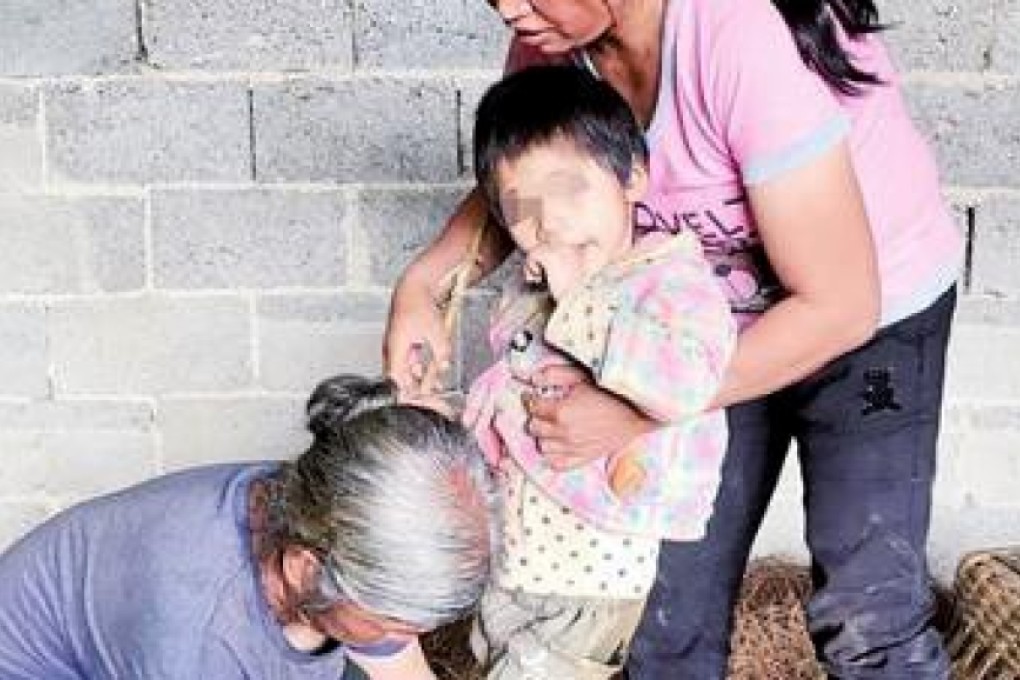 Migrant worker parents of Xiaoxinli, who suffered brain damage from a fever as an infant, are simply too poor to send her to hospital