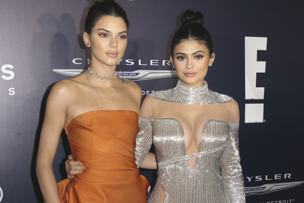Kendall Jenner, left, and sister Kylie Jenner, pictured at a Golden Globes party in Beverly Hills in January, apologised Thursday for selling “vintage” T-shirts superimposing their images with those of famous musicians. Photo: AP