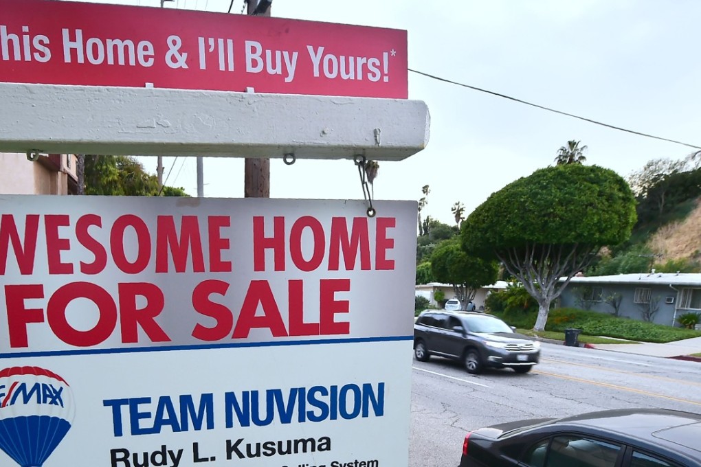 This file photo shows a for sale sign in Monterey Park, California. US economic growth was revised higher due to stronger levels of consumer spending. Photo: AFP