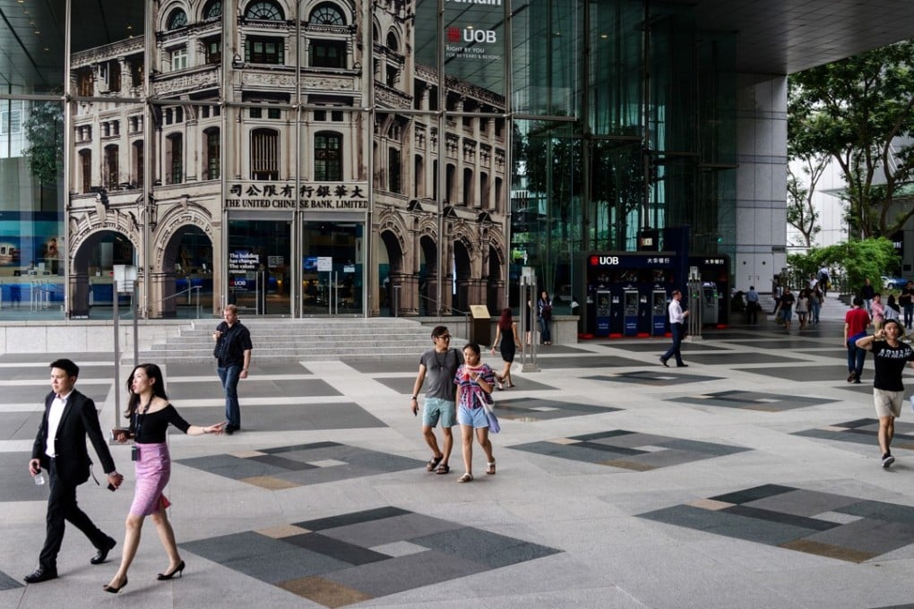 People walk in the central business district of Singapore. As recently as 1997, Hong Kong’s gross domestic product was above that of Singapore’s. But now, Singapore’s GDP per capita is US$51,855, compared with Hong Kong’s US$36,173, according to the World Bank. Photo: Bloomberg