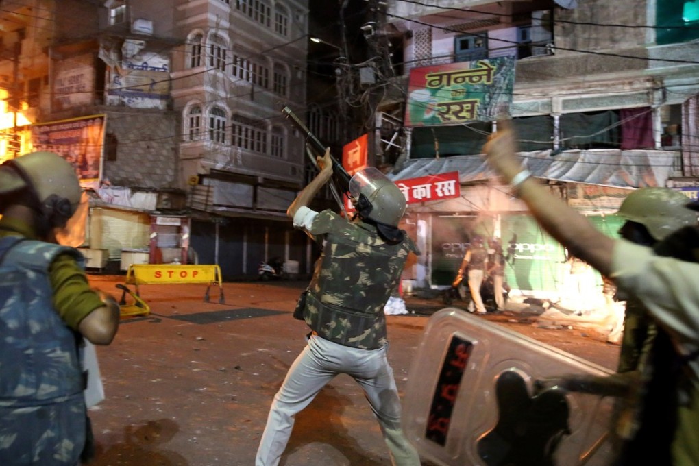 Police try to control a mob after riots erupted between two communities in Bhopal, India. Tension between Muslims and Hindus has increased over the right to pray inside the Hamidia Hospital complex in Bhopal's Old City. Photo: EPA