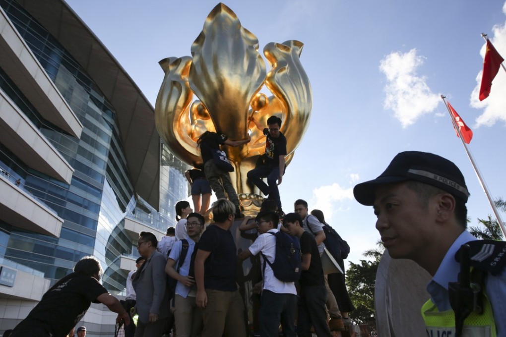 Activists protesting at the statue in Golden Bauhinia Square. Photo: Sam Tsang