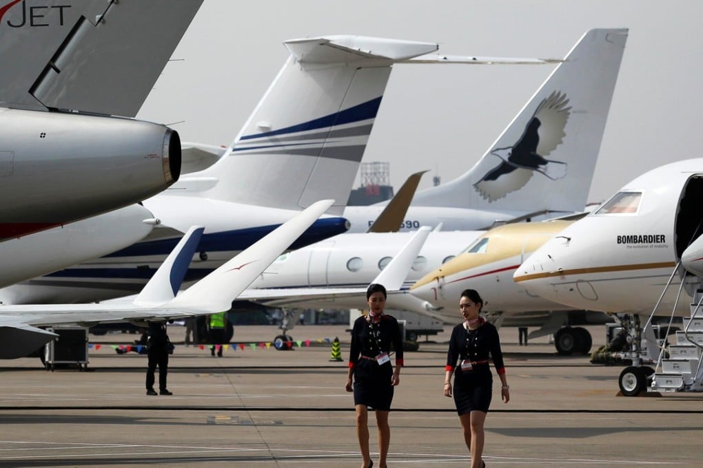 Crew members walk past business jets ahead of the Asian Business Aviation Conference and Exhibition at Shanghai’s Hongqiao Airport last April. Entrepreneurs in mainland China, Hong Kong and Taiwan wishing to charter personal jets currently have fewer options than counterparts elsewhere in Asia. Photo: AFP