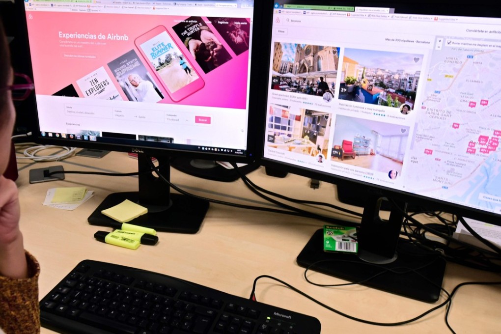 A woman uses a computer to visit home rental website Airbnb, in Madrid, Spain. Airbnb is about to launch rentals for luxury mansions and penthouses. Photo: AFP