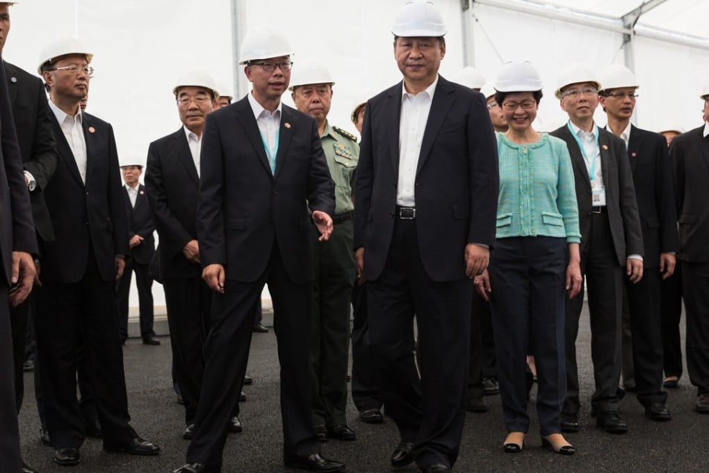 Hong Kong transport and housing secretary Frank Chan (centre left) speaks with Chinese President Xi Jinping (centre right) as Chief Executive Carrie (fourth from right) looks on. Photo: Bloomberg