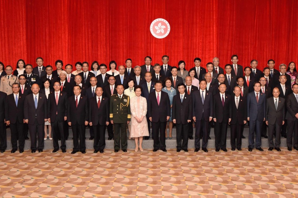 Carrie Lam poses with cabinet and Executive Council members and other dignitaries including President Xi Jinping. Photo: AFP