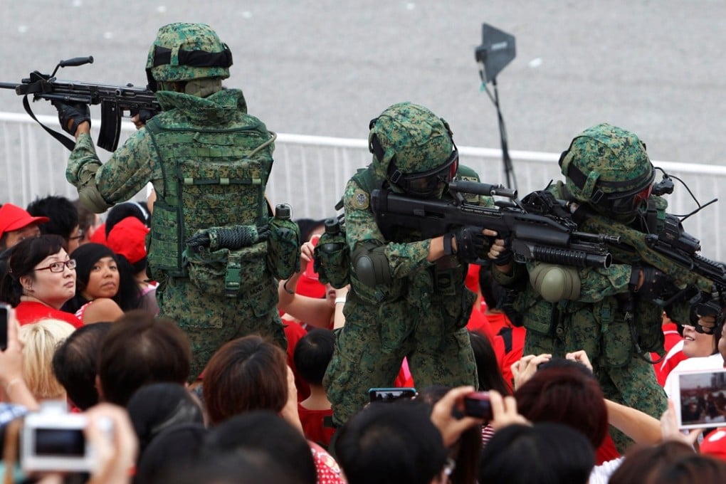 Singapore Armed Forces personnel perform a drill during National Day celebrations. Photo: Reuters