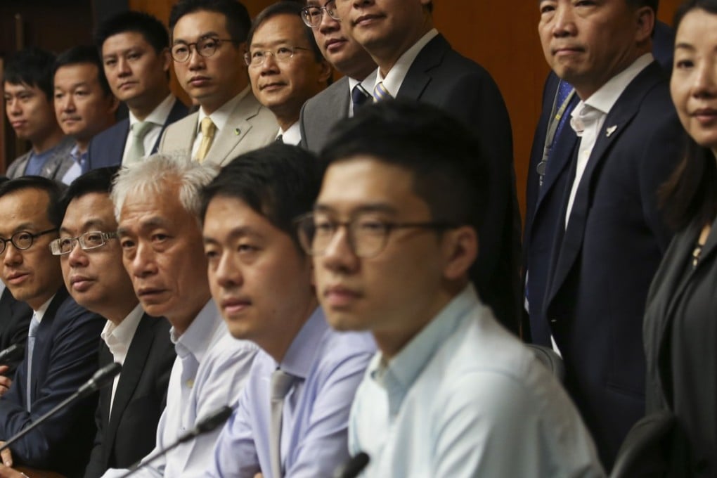 Pan-democrats join Kenneth Leung (second from left, front) in a show of force against Chief Executive Leung Chun-ying over his UGL saga. Only nine attended the recent banquet welcoming Chinese President Xi Jinping. Photo: David Wong
