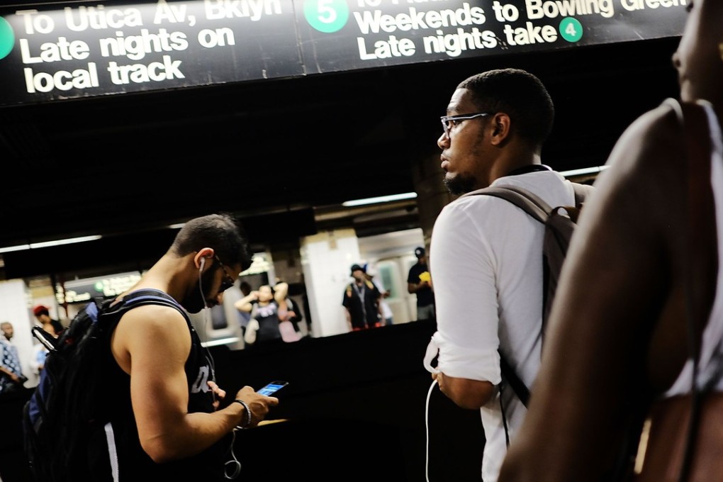 Passengers wait for a train to arrive. Photo: AFP