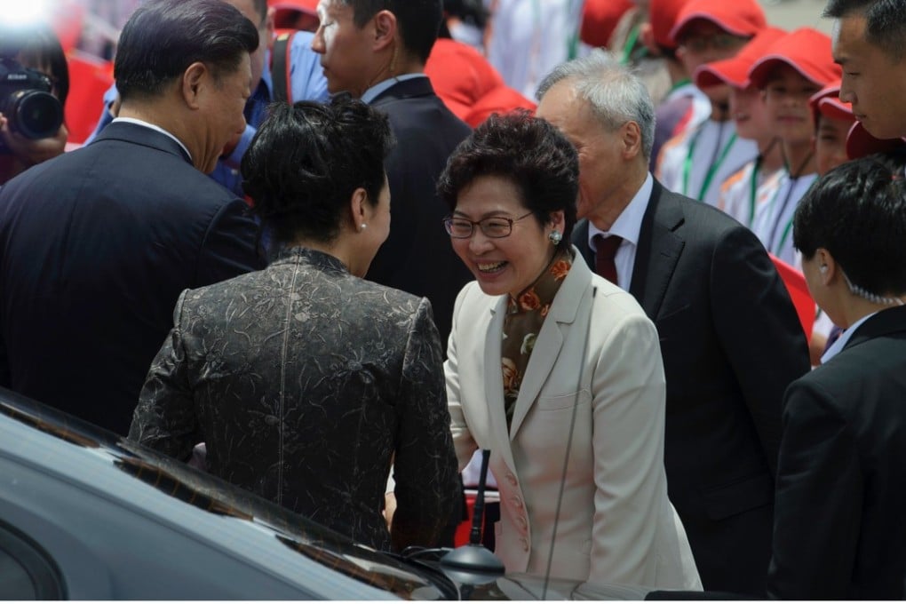 New Chief Executive Carrie Lam shakes hands with Peng Liyuan at the airport shortly before the first lady’s departure for Beijing. Photo: AFP