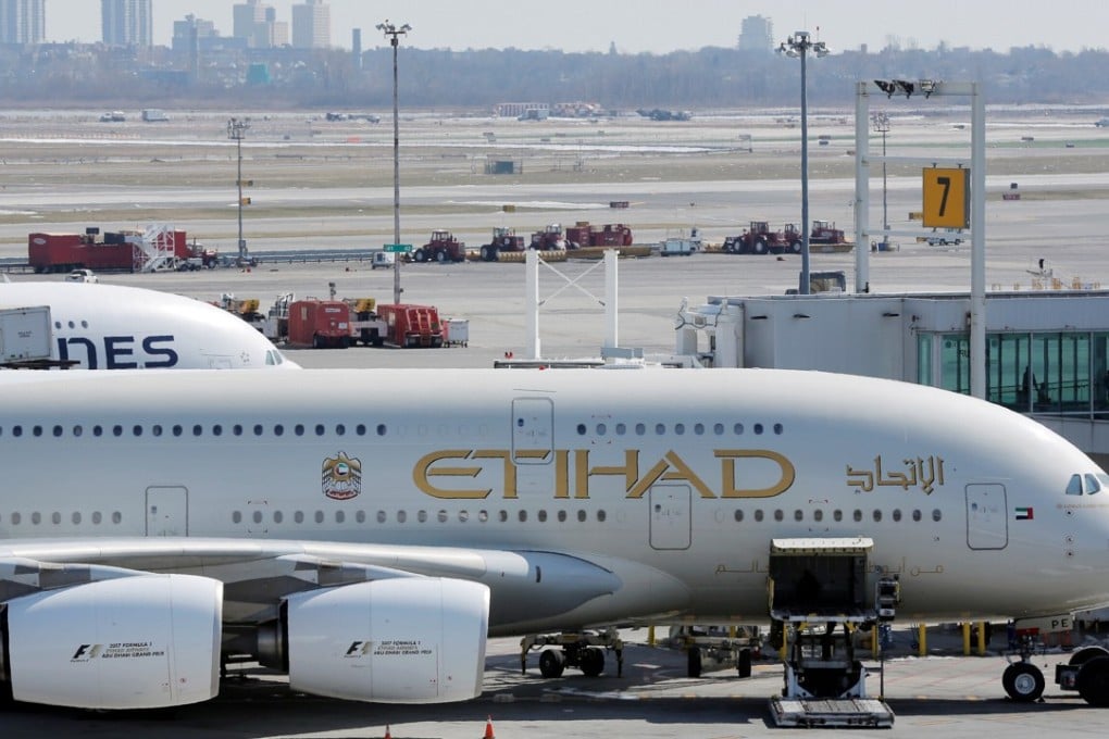 An Etihad plane stands parked at a gate at JFK International Airport in New York. Photo: Reuters